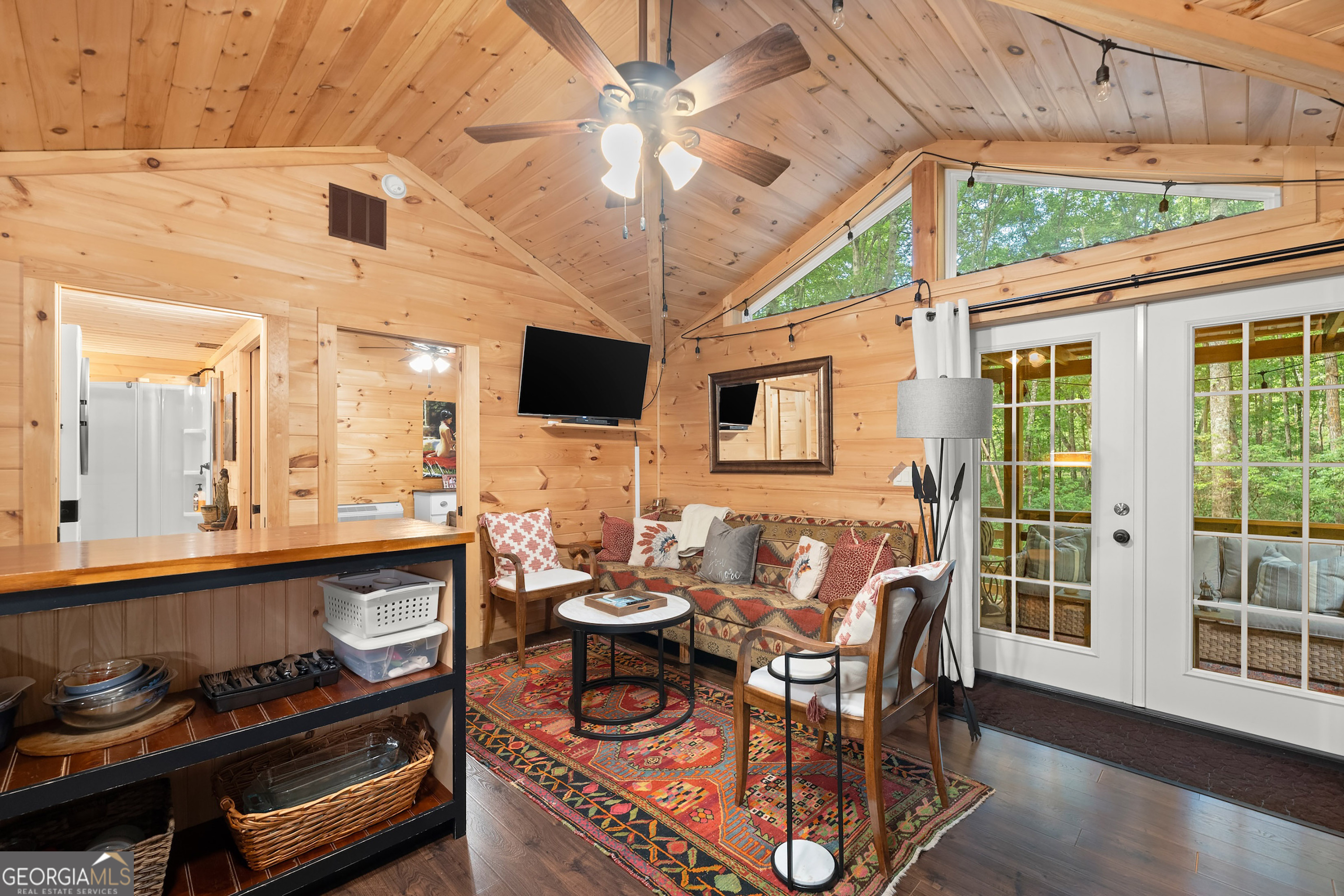 3103 Highway 197 Clarkesville, GA 30523 - Photo 15 of 30 a dining room with furniture a flat screen tv and a chandelier