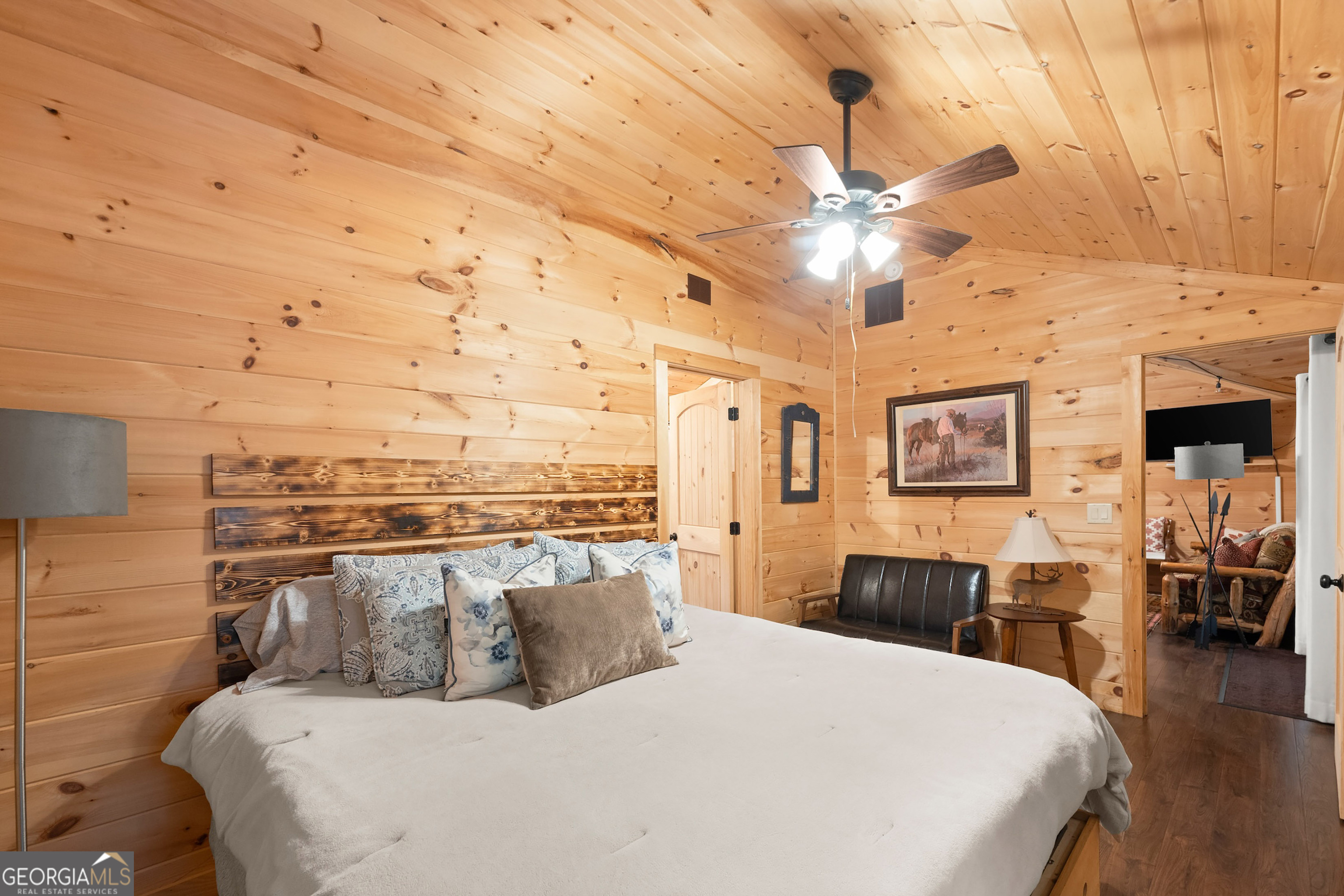 3103 Highway 197 Clarkesville, GA 30523 - Photo 17 of 30 a bedroom with a large bed and a chandelier