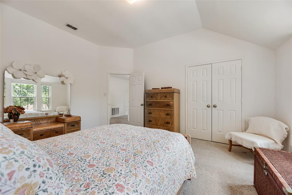 1406 West Peters Colony Road Carrollton, TX 75007 - Photo 16 of 29 a bedroom with a bed and furniture