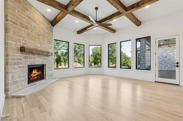 a view of an empty room with a fireplace and a window
