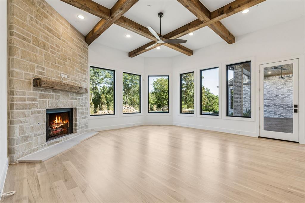 871 Beechwood Lane Fairview, TX 75069 - Photo 12 of 40 a view of an empty room with a fireplace and a window