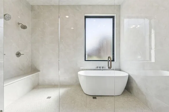a bathroom with a bathtub and shower