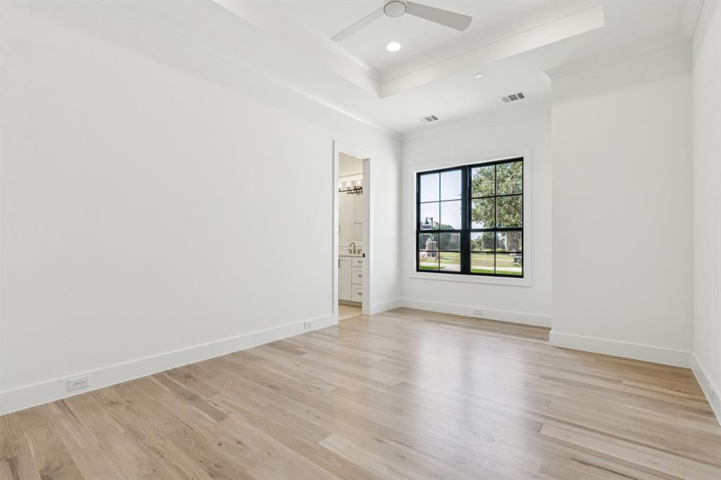 871 Beechwood Lane Fairview, TX 75069 - Photo 21 of 40 an empty room with wooden floor and windows