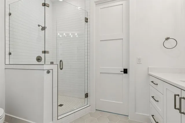 a bathroom with a glass shower door