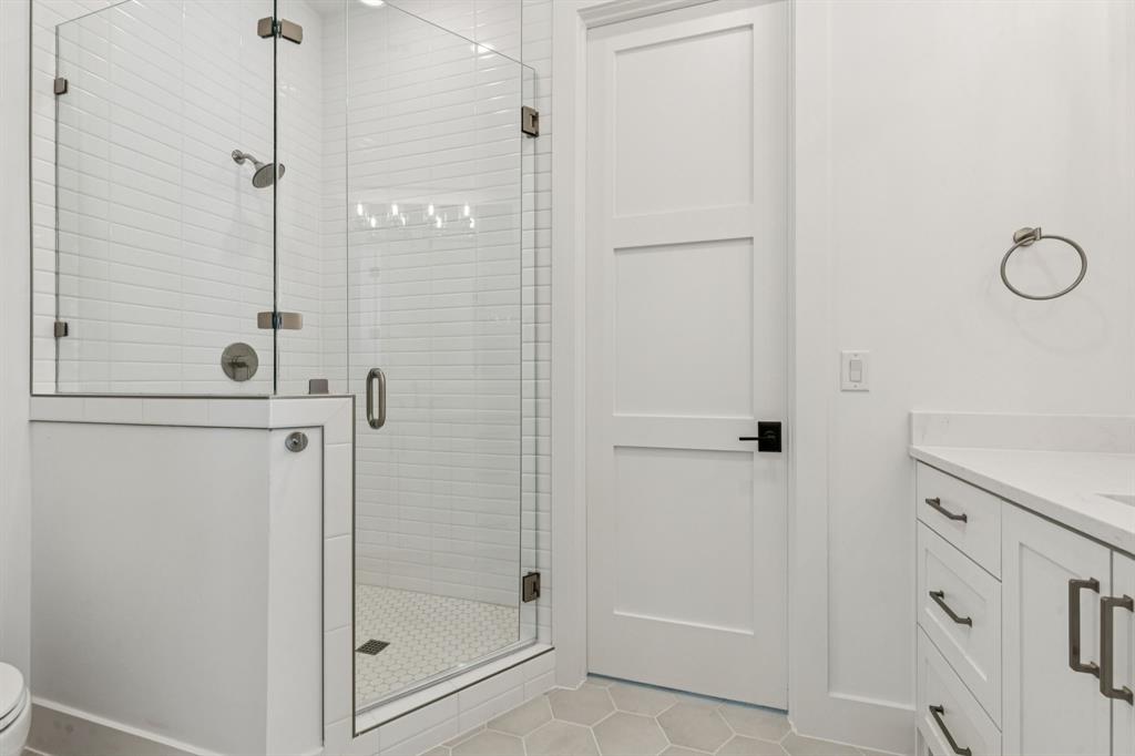 871 Beechwood Lane Fairview, TX 75069 - Photo 22 of 40 a bathroom with a glass shower door
