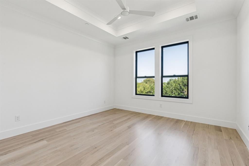 871 Beechwood Lane Fairview, TX 75069 - Photo 25 of 40 an empty room with wooden floor and windows