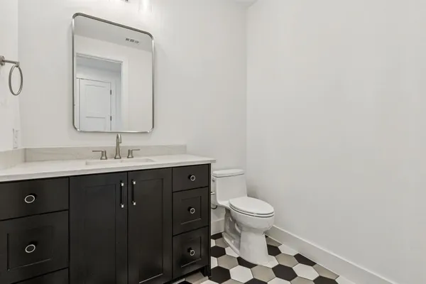 a bathroom with a sink a toilet a shower and a mirror