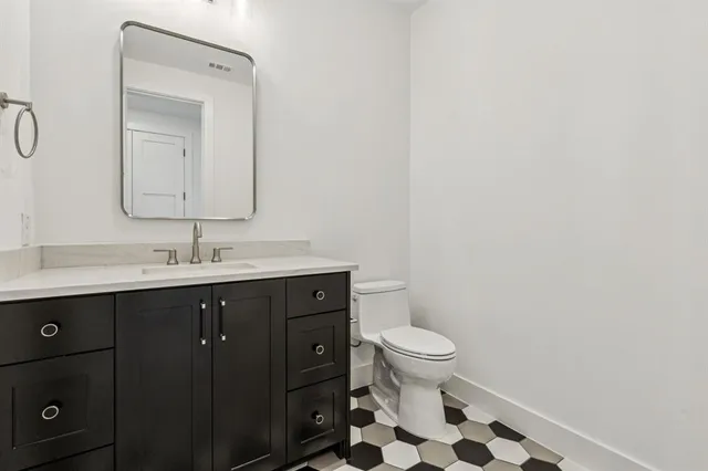 a bathroom with a sink a toilet a shower and a mirror