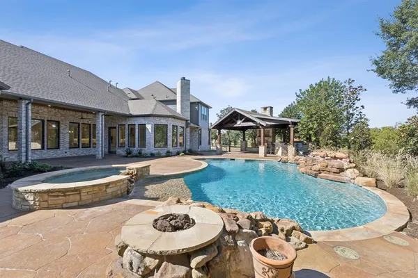 a view of house with swimming pool and yard