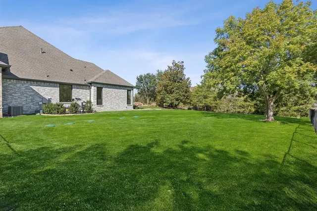 a view of house with backyard