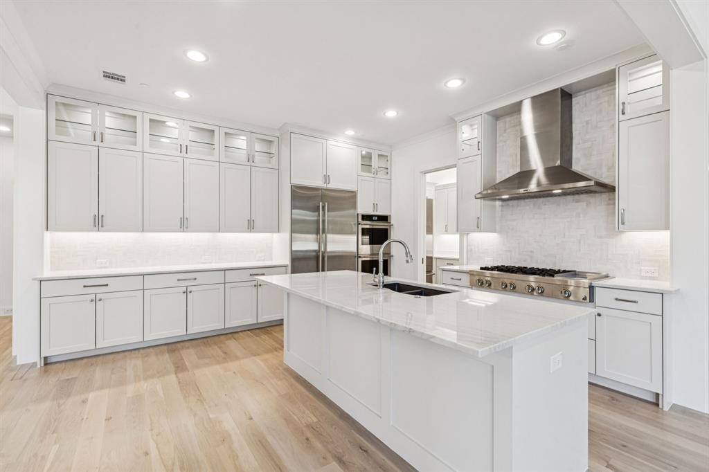 871 Beechwood Lane Fairview, TX 75069 - Photo 9 of 40 a kitchen with stainless steel appliances granite countertop a sink stove and refrigerator