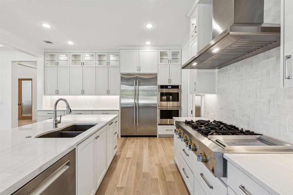 871 Beechwood Lane Fairview, TX 75069 - Photo 10 of 40 a kitchen with stainless steel appliances granite countertop a sink stove and refrigerator