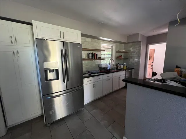 a kitchen with a refrigerator a sink and a stove