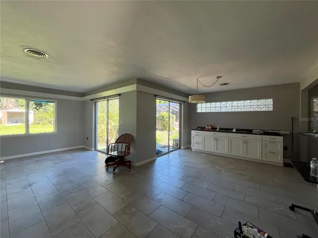 a view of a room with gym equipment and windows