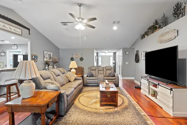 a living room with furniture and a flat screen tv