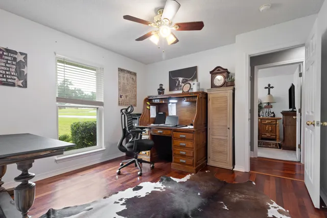 a living room with furniture a window and a chandelier