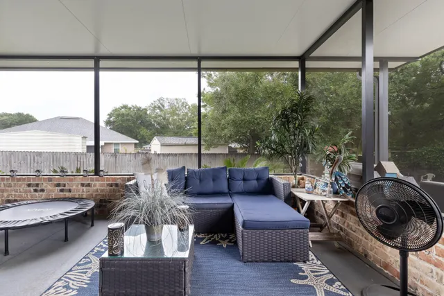 a view of a livingroom with furniture and floor to ceiling window