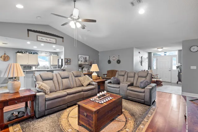 a living room with furniture and a chandelier