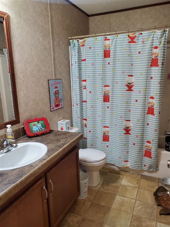 8251 Edith-Nankipoo Road Ripley, TN 38063 - Photo 13 of 17 a bathroom with a sink toilet vanity and shower