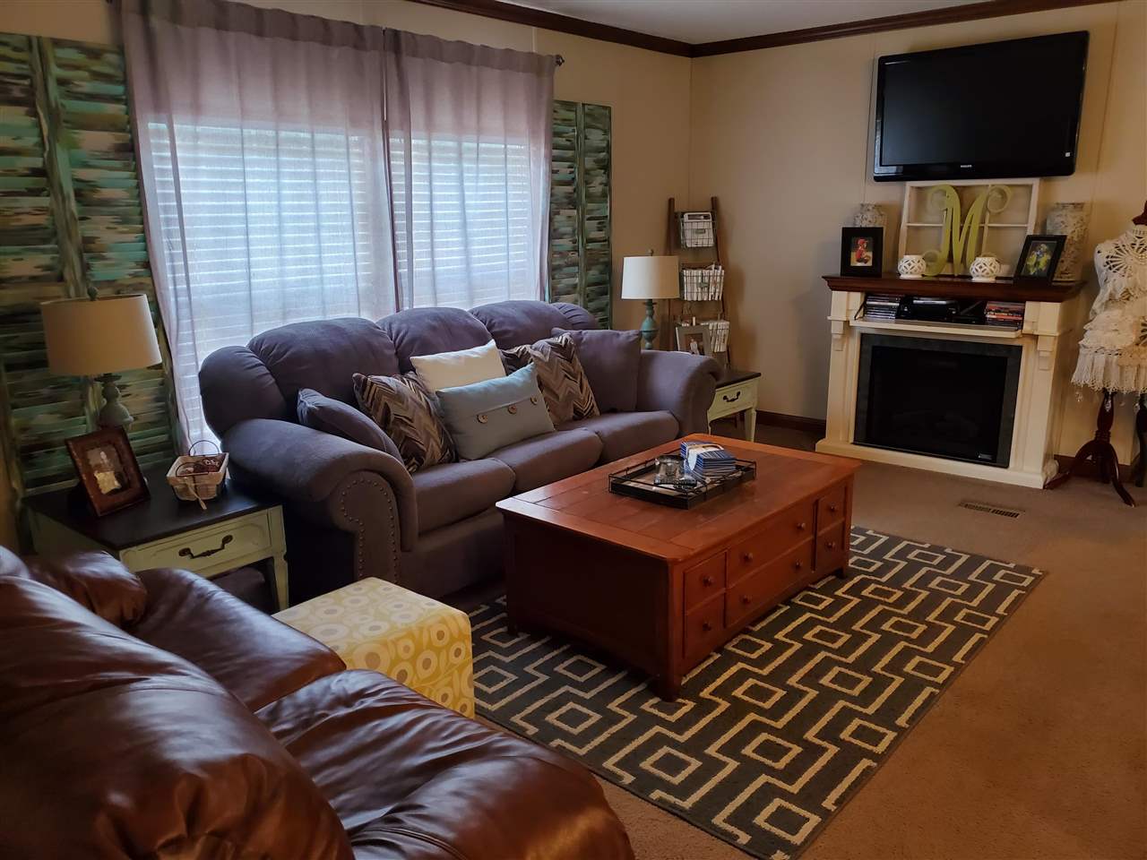 8251 Edith-Nankipoo Road Ripley, TN 38063 - Photo 4 of 17 a living room with furniture a flat screen tv and a fireplace