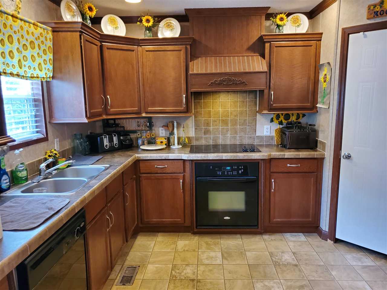 8251 Edith-Nankipoo Road Ripley, TN 38063 - Photo 7 of 17 a kitchen with stainless steel appliances granite countertop a stove a sink and a microwave