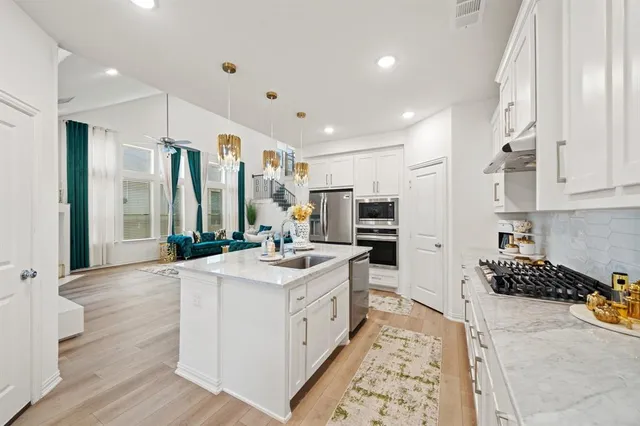 a kitchen with a sink stove and cabinets