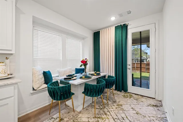 a dining room with furniture and wooden floor