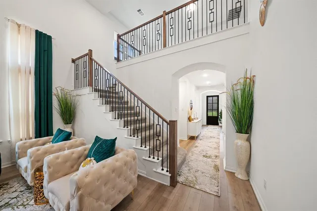 a view of entryway and hall with wooden floor