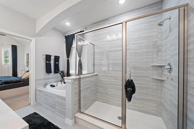 a bathroom with a bathtub and a shower