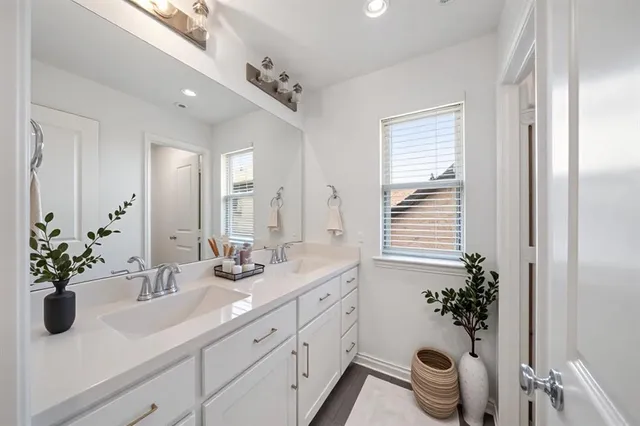 a bathroom with a sink a large mirror and a shower