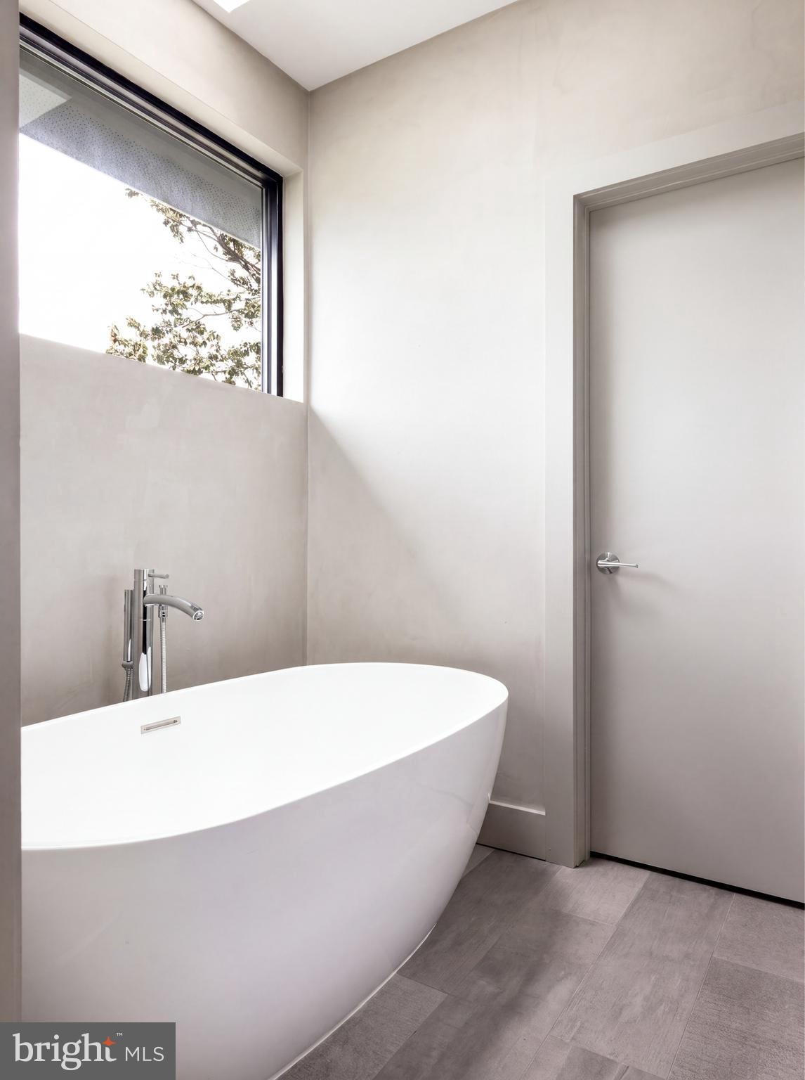 1522 Foxhall Road Northwest Washington, DC 20007 - Photo 29 of 47 a white bath tub sitting in a bathroom