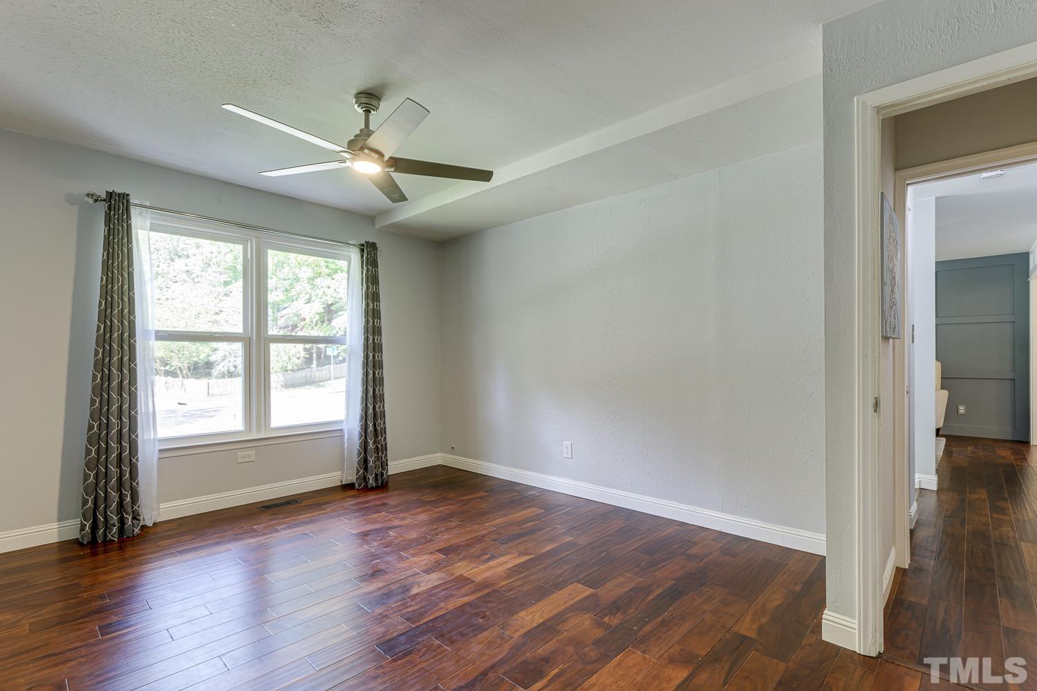 3516 Donna Road Raleigh, NC 27604 - Photo 17 of 41 an empty room with wooden floor fan and windows