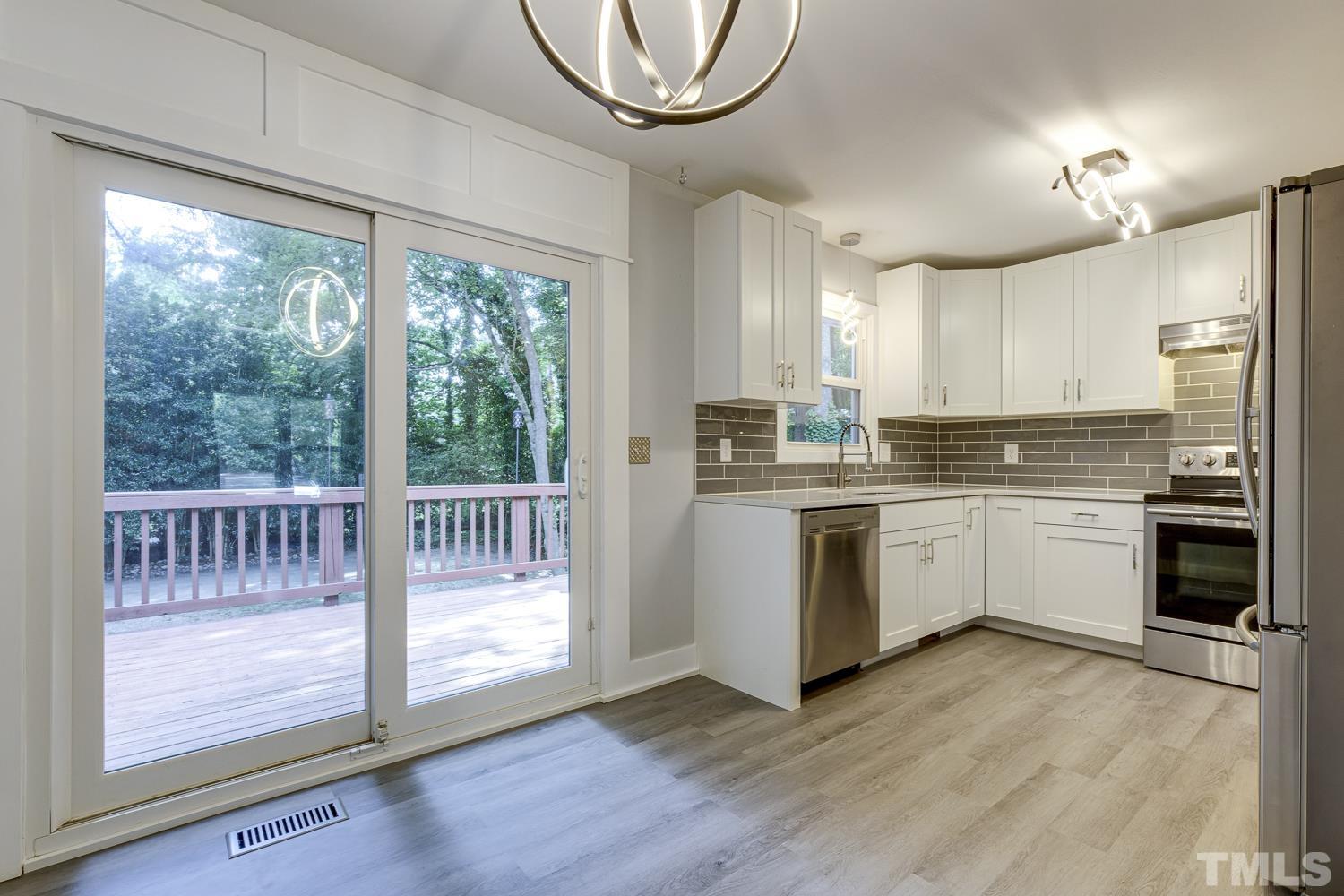 3516 Donna Road Raleigh, NC 27604 - Photo 33 of 41 a kitchen with stainless steel appliances a white stove top oven sink and window