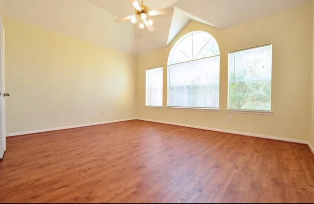 wooden floor in an empty room with a window