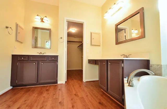 a spacious bathroom with a granite countertop sink and a mirror