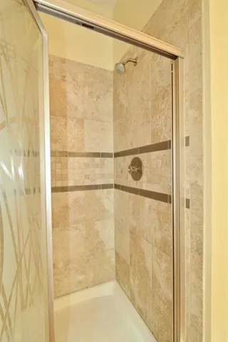a bathroom with a glass shower door