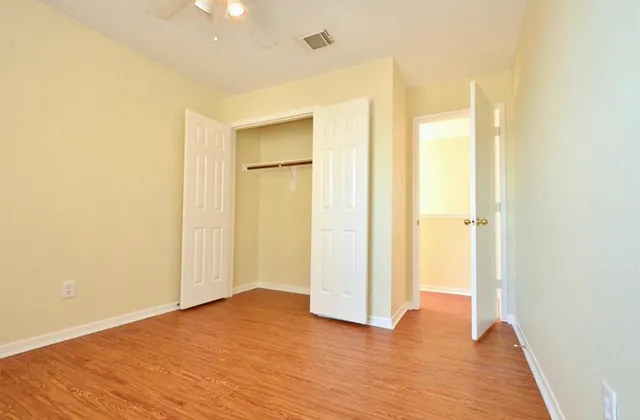 a view of a room with wooden floor and brick wall