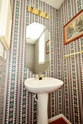 a bathroom with a sink a mirror and a window