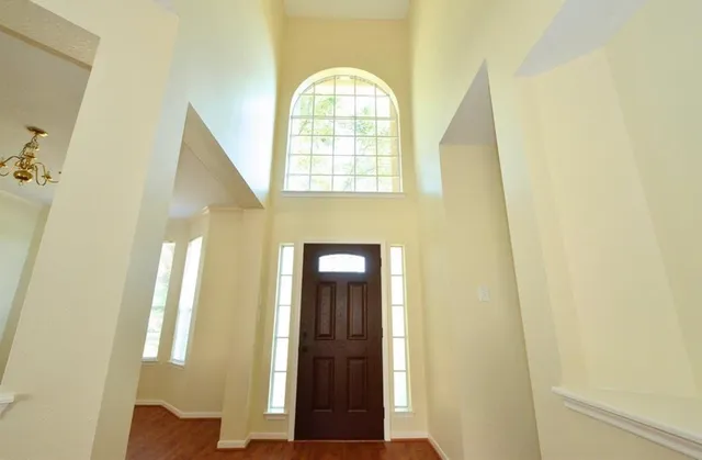 a view of an entryway with wooden floor