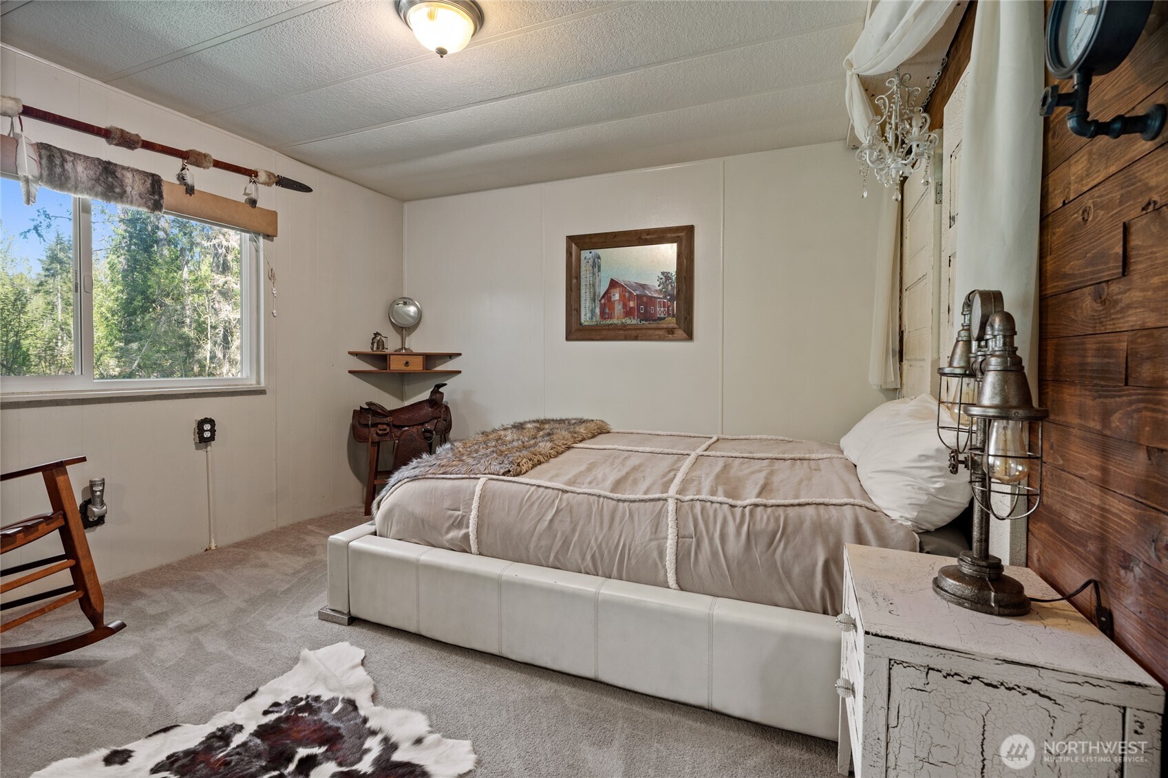 271 Skate Creek Road North Ashford, WA 98304 - Photo 16 of 40 a bedroom with a bed and a window