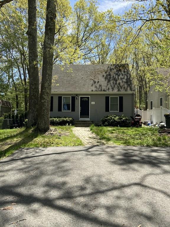 62 Indian Run Road Bellingham, MA 02019 - Photo 2 of 2 a front view of a house with a yard and potted plants
