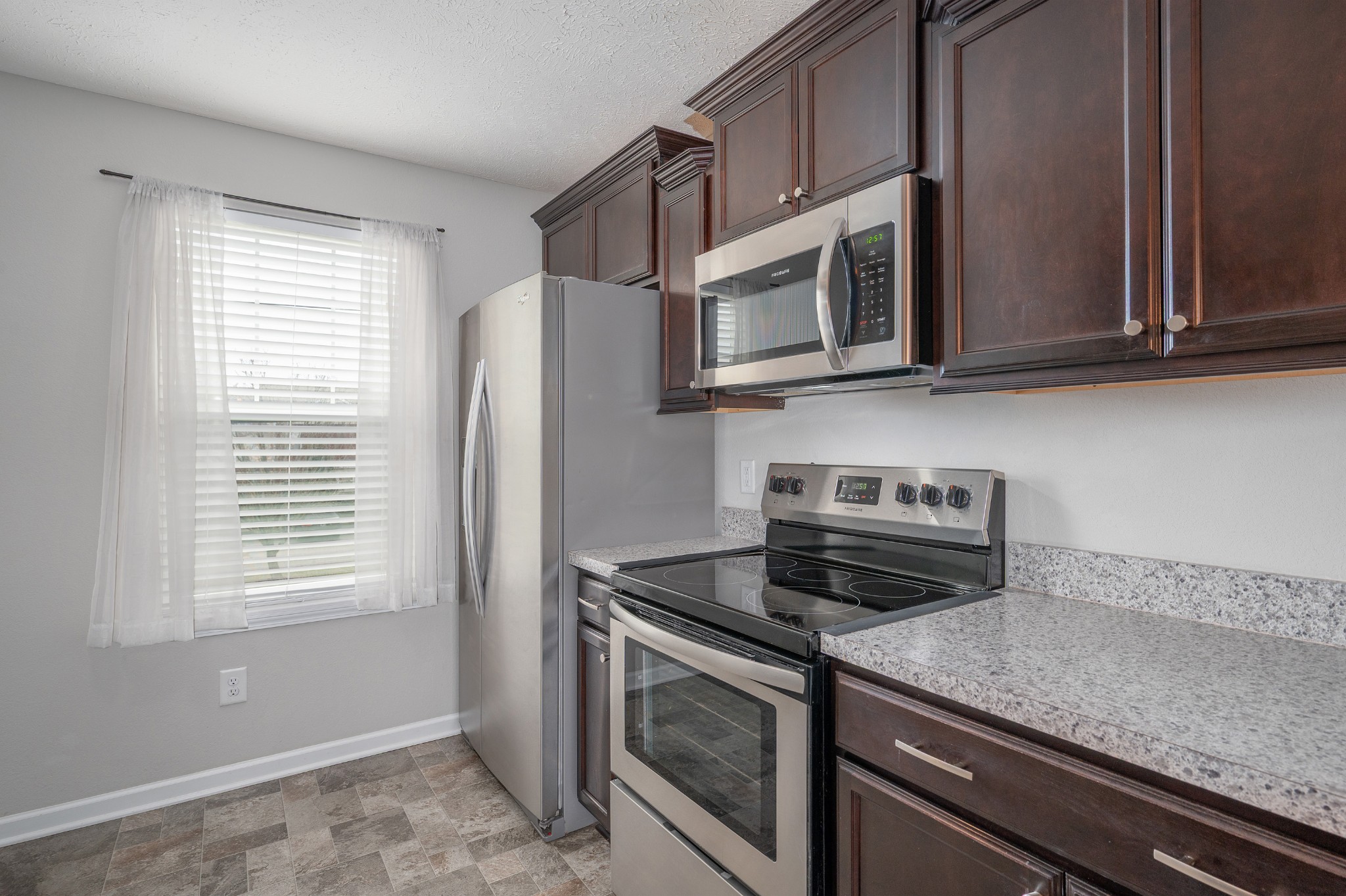 118 Ramsden Avenue La Vergne, TN 37086 - Photo 11 of 24 a kitchen with stainless steel appliances granite countertop white cabinets and a microwave oven