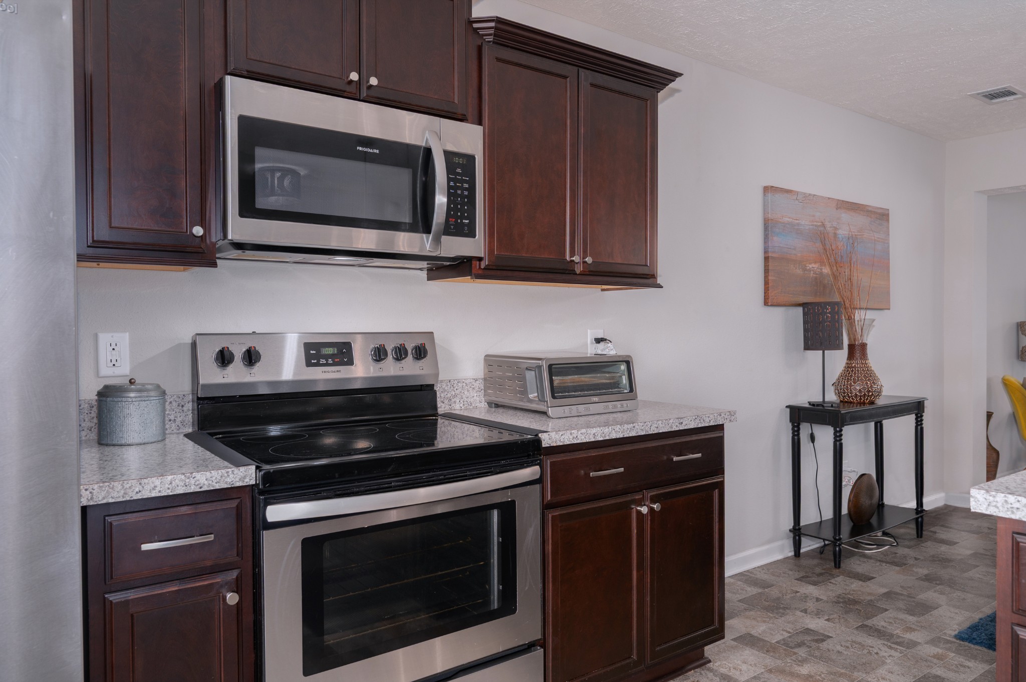 118 Ramsden Avenue La Vergne, TN 37086 - Photo 16 of 33 a kitchen with stainless steel appliances granite countertop a stove microwave and sink