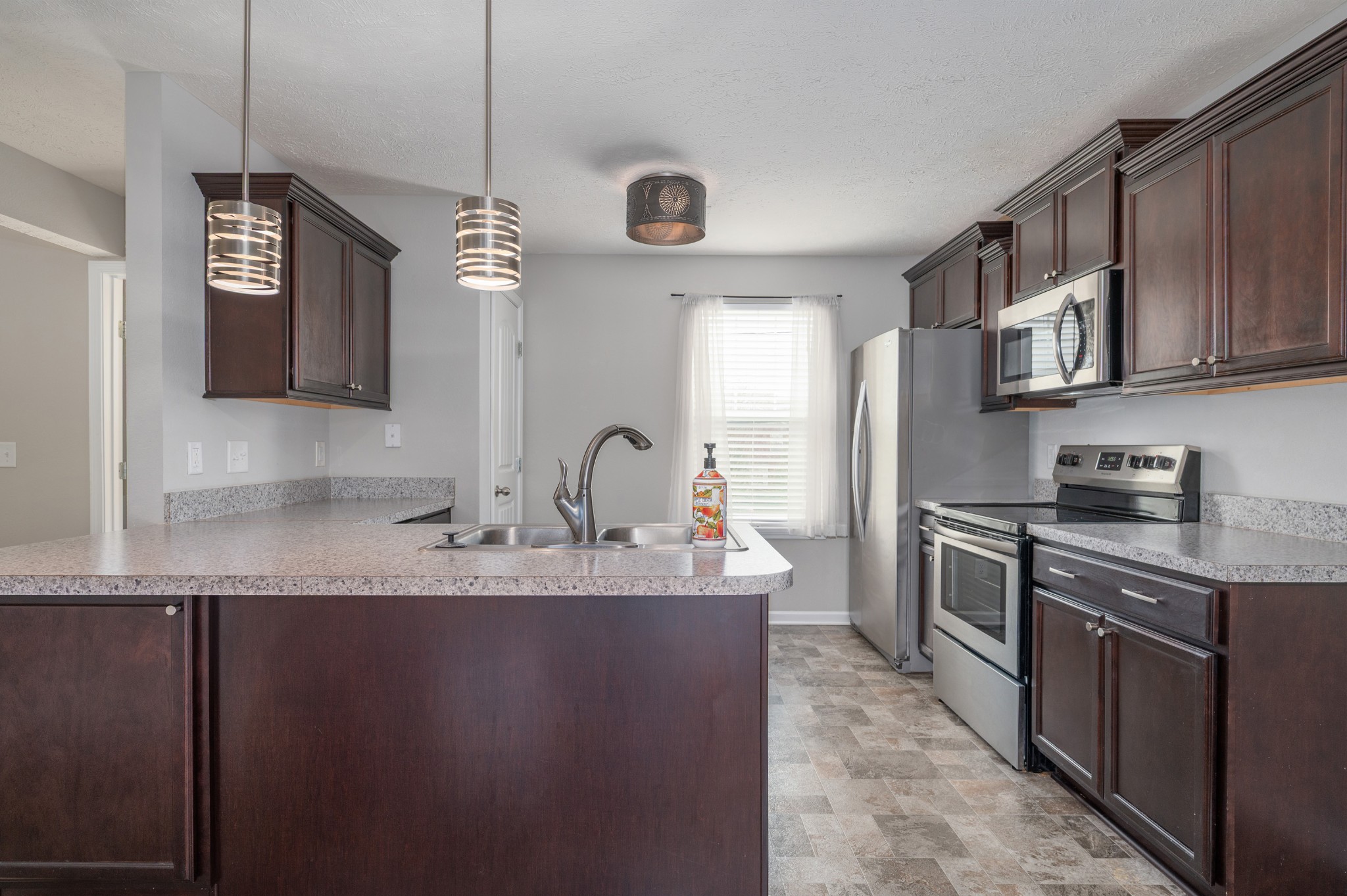 118 Ramsden Avenue La Vergne, TN 37086 - Photo 10 of 24 a kitchen with stainless steel appliances granite countertop a sink a stove and a refrigerator