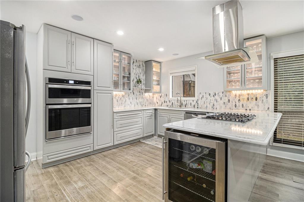 3211 Olde Dekalb Way Atlanta, GA 30340 - Photo 12 of 38 a kitchen with kitchen island granite countertop a stove and a refrigerator