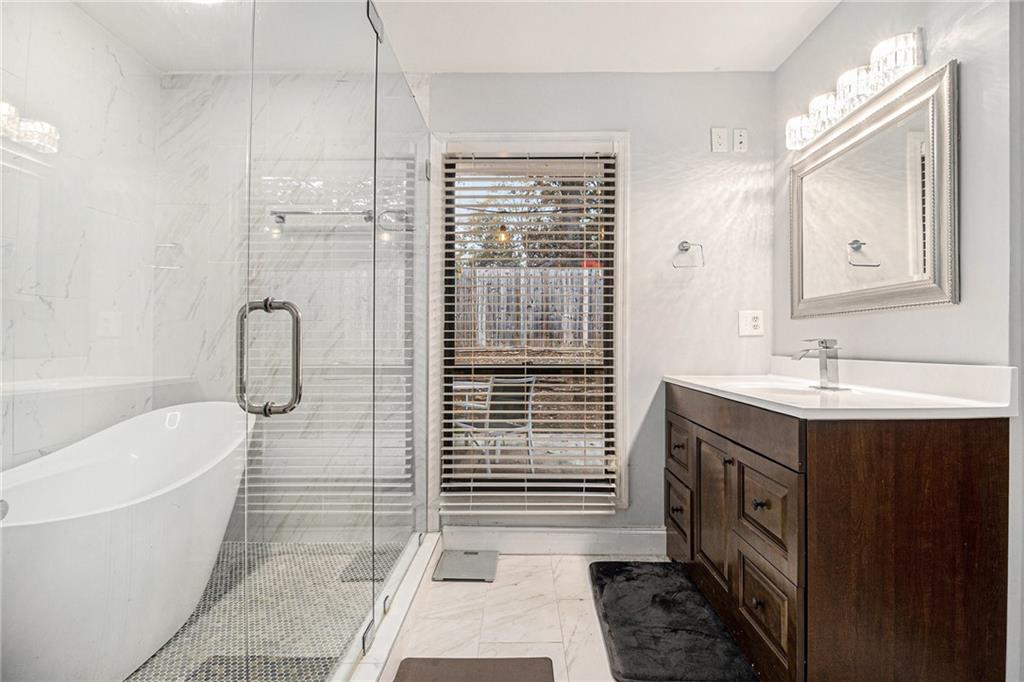 3211 Olde Dekalb Way Atlanta, GA 30340 - Photo 20 of 38 a bathroom with a sink a toilet a mirror and shower
