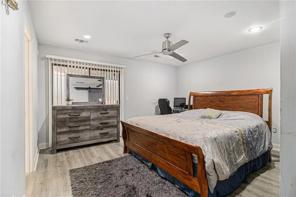 a bedroom with a bed and cabinet