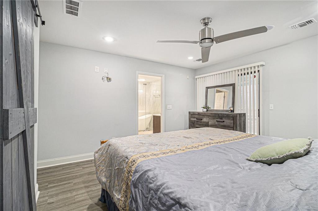 3211 Olde Dekalb Way Atlanta, GA 30340 - Photo 26 of 38 a bedroom with a large bed and a chandelier