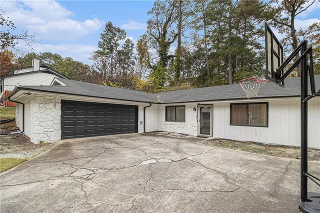 a view of a house with a yard and garage