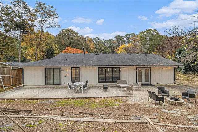 a front view of a house with swimming pool and a fire pit